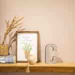 Collective Home mirrored glass letter C mounted on a bedroom wall
