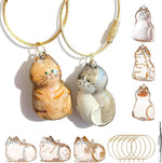 BY669QFC cat fur storage bottle keychain front view showing six clear cat-shaped capsule pendants with tweezers