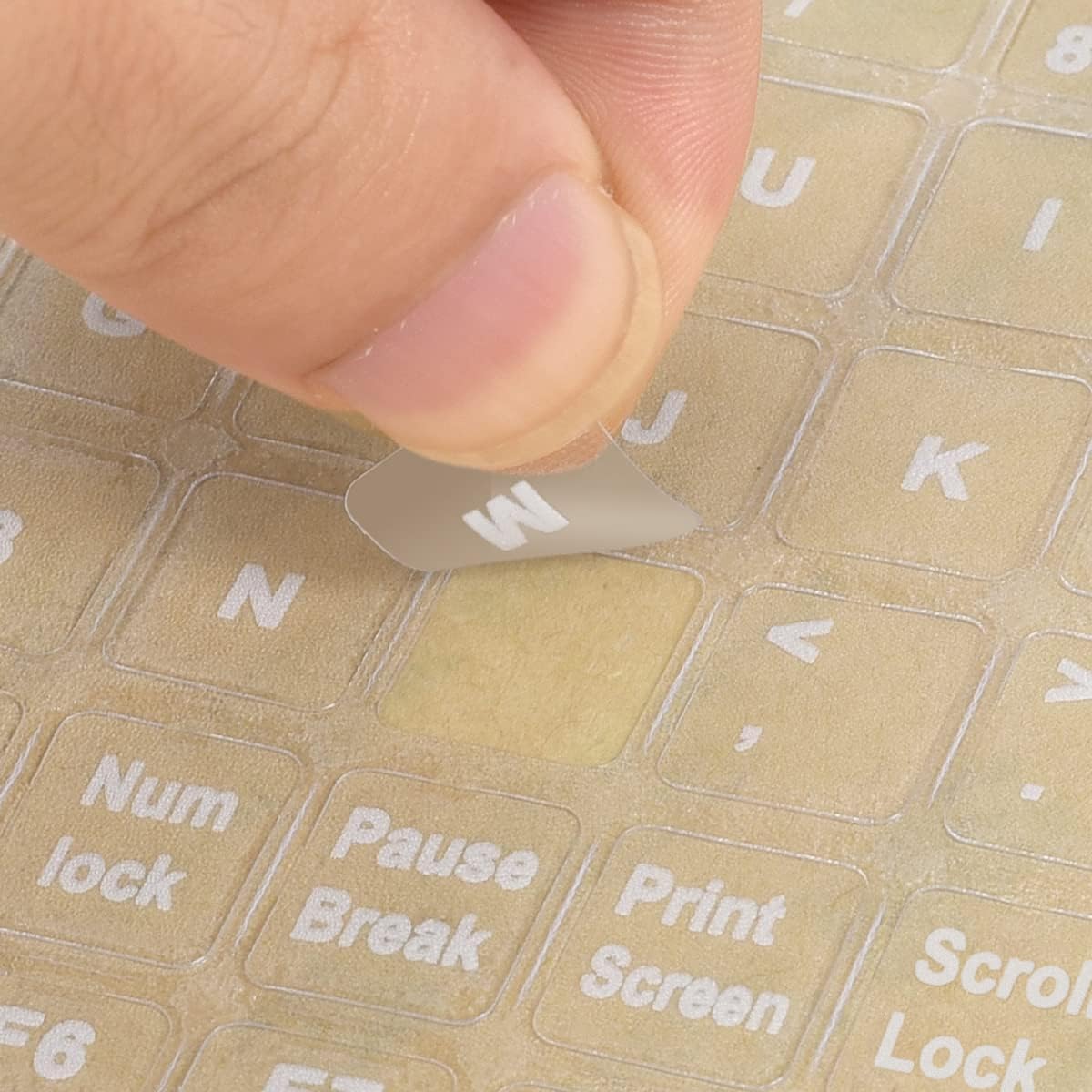 imComor universal English keyboard stickers front view showing transparent sheet with white letters.