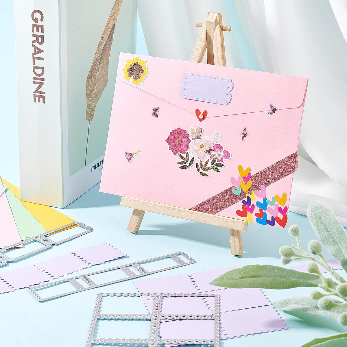 Postage stamp border cutting dies placed on colorful cardstock