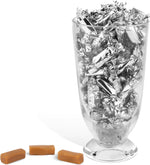 Assorted silver foil caramels by Candy Envy poured into a crystal candy bowl.