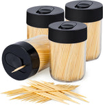 Urbanstrive Sturdy Safe Toothpick Holder front view showing black lid and clear acrylic dispenser packed with natural wood toothpicks.