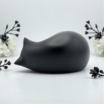 Comemori sleeping cat animal ashes container alongside the included airtight preservation pouch