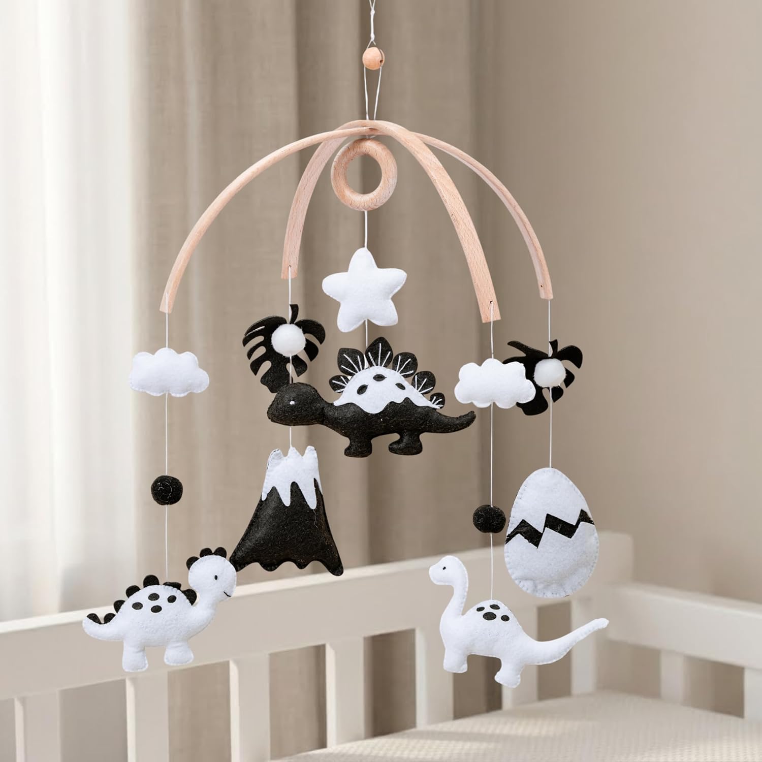 MiniMeMobiles Dinosaur Crib Mobile front view hanging over a modern white infant bassinet.