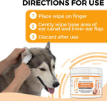 Single Nootie finger wipe placed on an index finger for mess free pet ear cleaning.