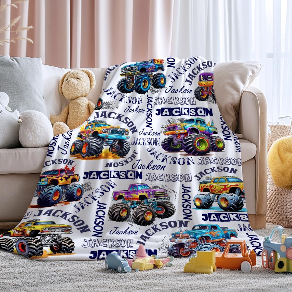 Generic personalized monster truck blanket front view displaying customized text and bright vehicle patterns.