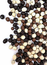Whole roasted espresso coffee beans inside a broken chocolate coating