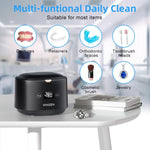 Portable ultrasonic cleaner cleaning dental aligners inside water pod