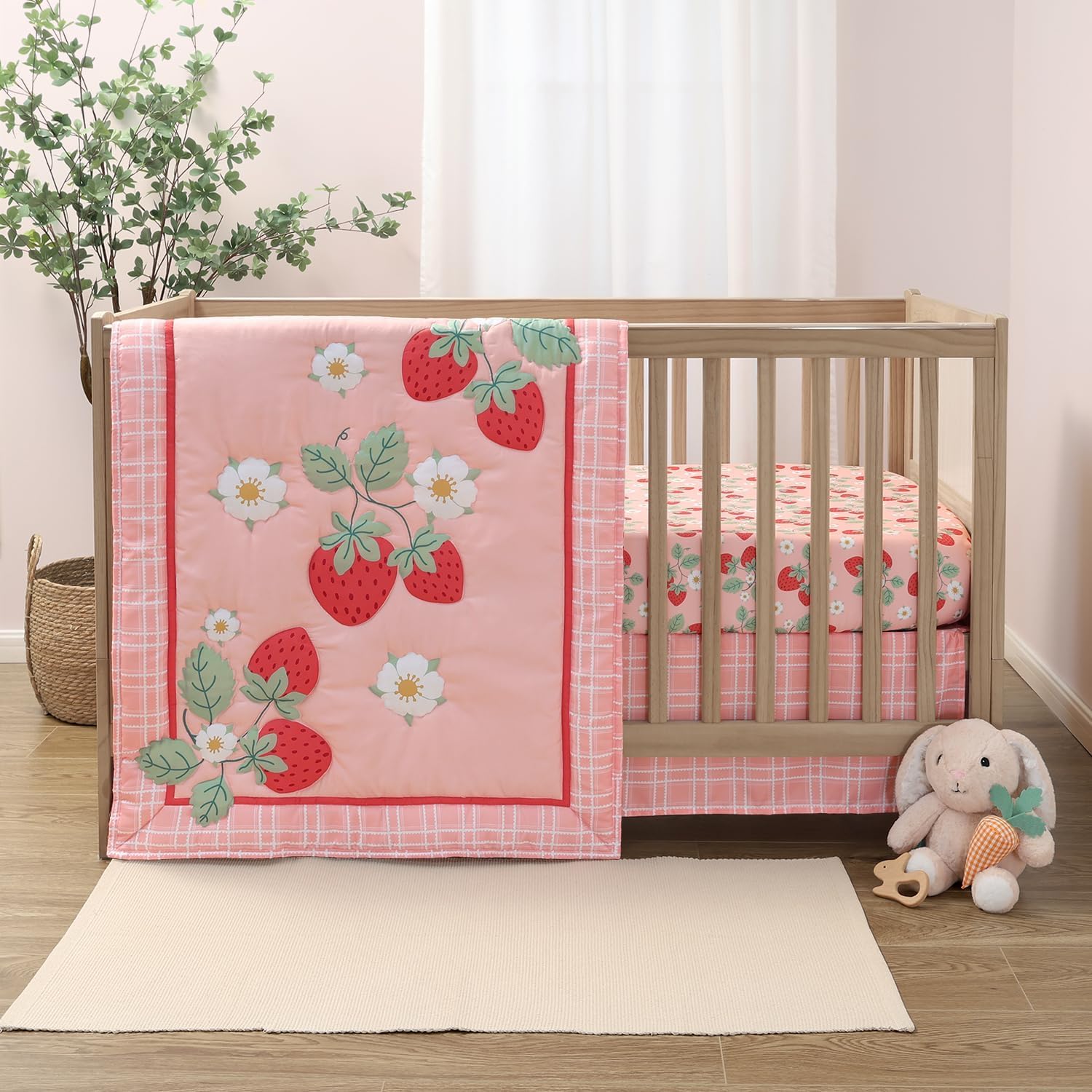 The Peanutshell Strawberry Sweet baby bedding set front view showcasing the quilted pink comforter