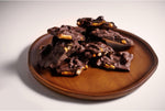 Dark chocolate pretzel bark pieces in a bowl