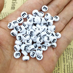 White round letter beads with black print closeup