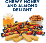 Honey and almond taffy pieces scattered around bulk candy pouch