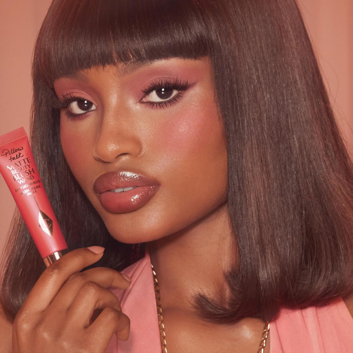 Swatches of Charlotte Tilbury Pillow Talk matte blush on different skin undertones.