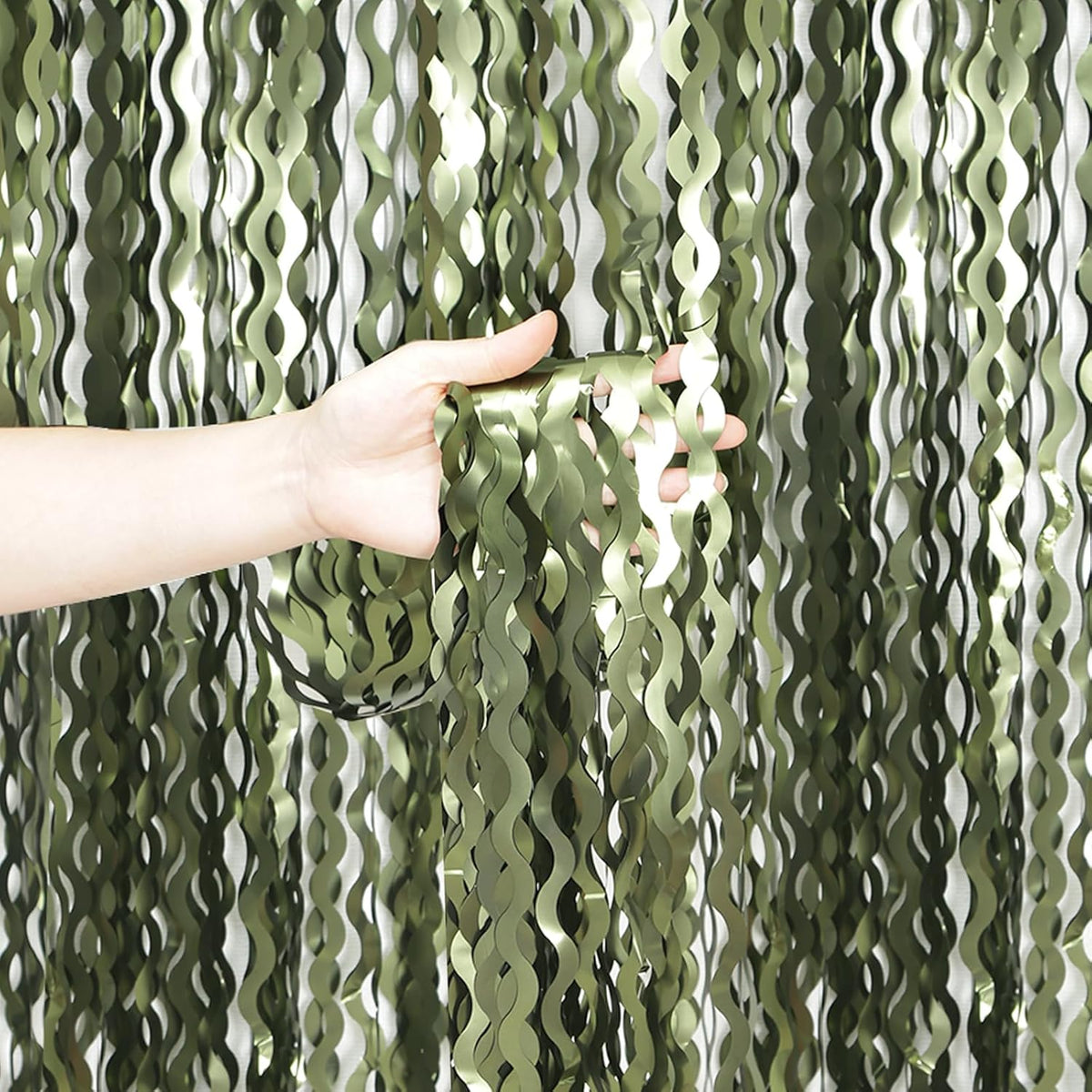 KEEUH wavy olive green streamers backdrop front view for jungle party decorations.