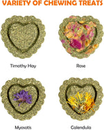 Handmade heart-shaped timothy hay cakes with dried flower toppings for rabbits.