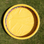 CHICLIST kids inflatable swimming pool front view showing the three jungle themed rings inflated in a backyard garden setting.