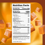 A mountain of individually wrapped vanilla flavor chewy caramel squares spilled on a table