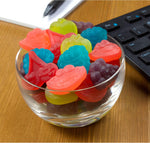 Watermelon cherry and grape flavored soft gummy treats poured out of the original import bag