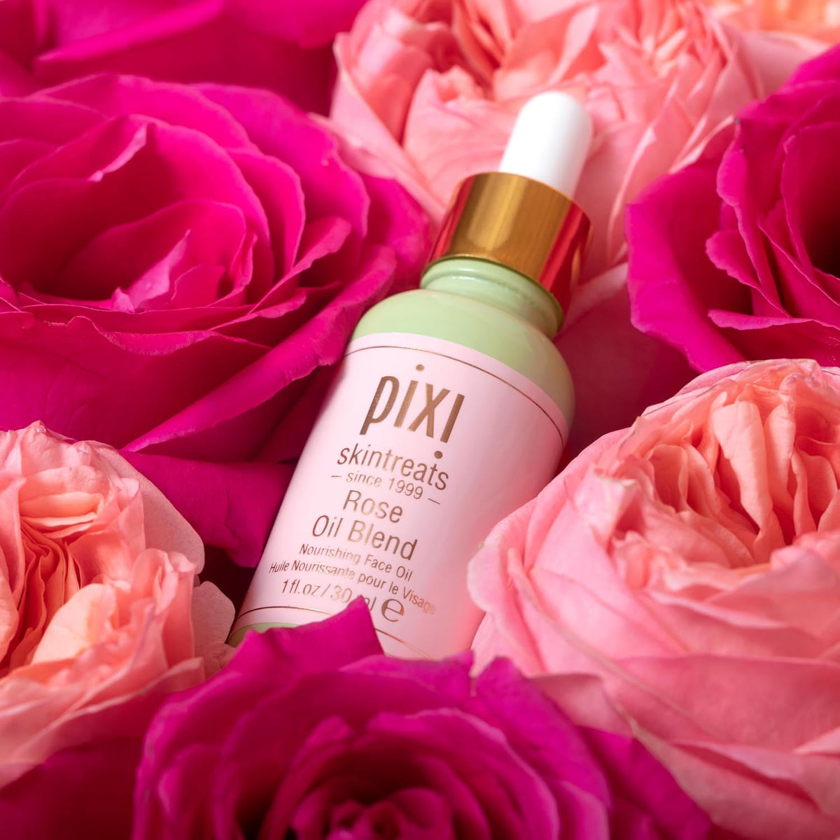 Side profile of Pixi Beauty Rose Oil glass bottle