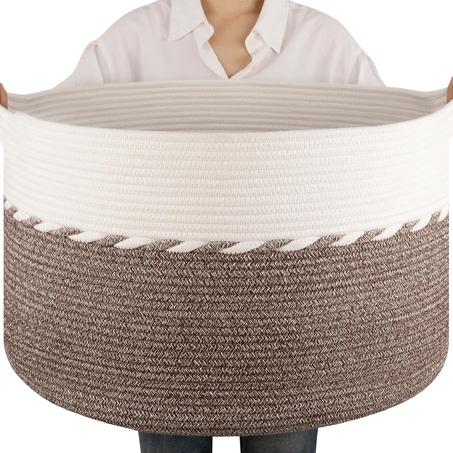 OIAHOMY 90L blanket basket front view holding brown and white throw blankets in a living room setup.