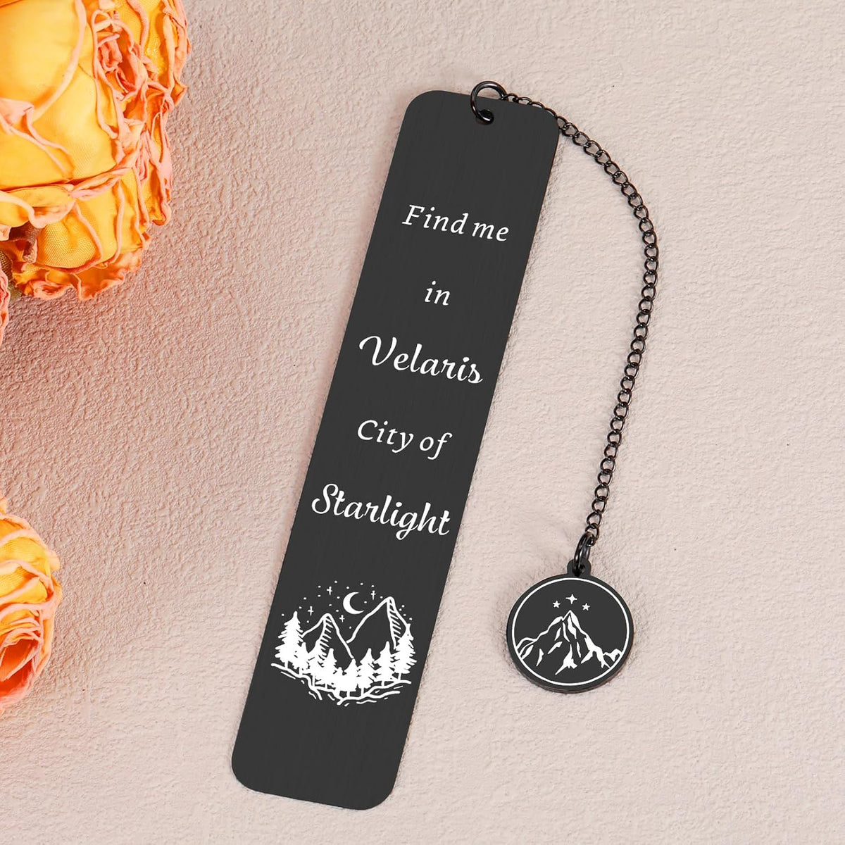 Book lovers gift metal bookmark placed inside an open fantasy novel