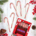 Authentic American peppermint candy canes used as decorative elements for a gingerbread house.
