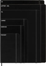 Moleskine extra large notebook laid flat on a desk