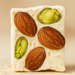 Texture shot of the chewy white honey nougat base filled with premium European mixed nuts.
