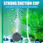 Soft plastic aquarium tubing clips being applied to a clean fish tank glass wall.