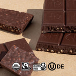 Hu dark chocolate bar broken into squares highlighting the organic puffed quinoa.