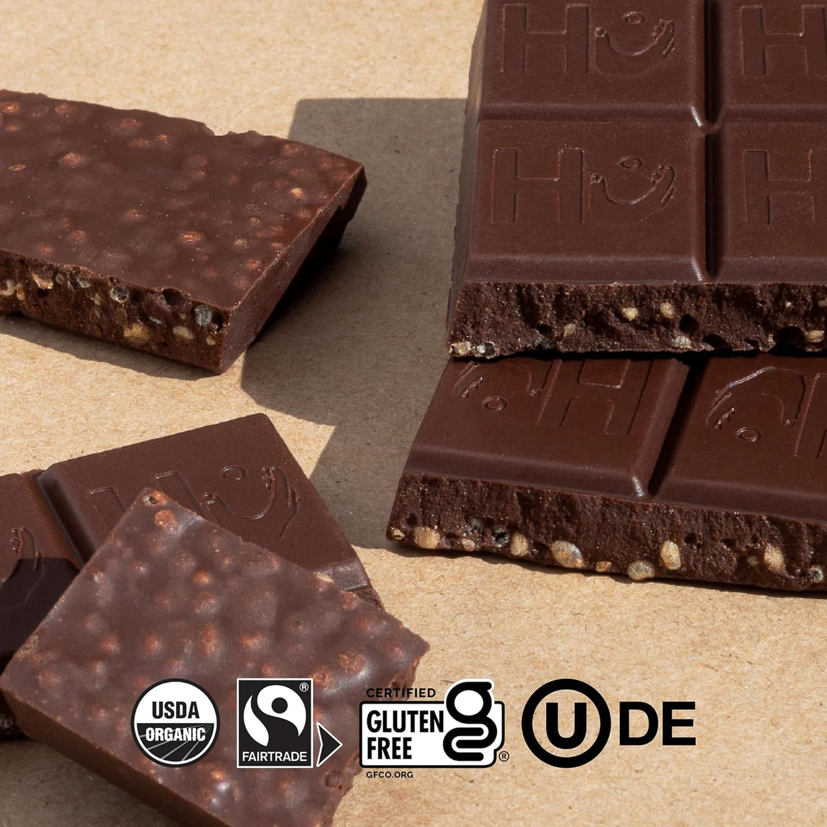 Hu dark chocolate bar broken into squares highlighting the organic puffed quinoa.
