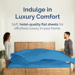 CGK Unlimited denim blue flat sheet draped on a bed