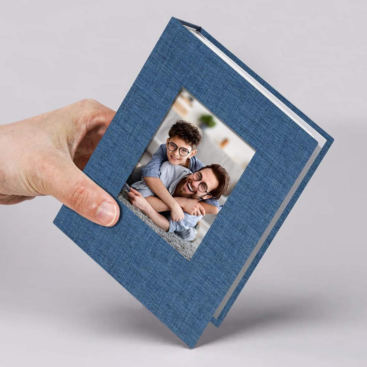 Vienrose small photo album 4x6 front view showing blue linen texture and round photo window.