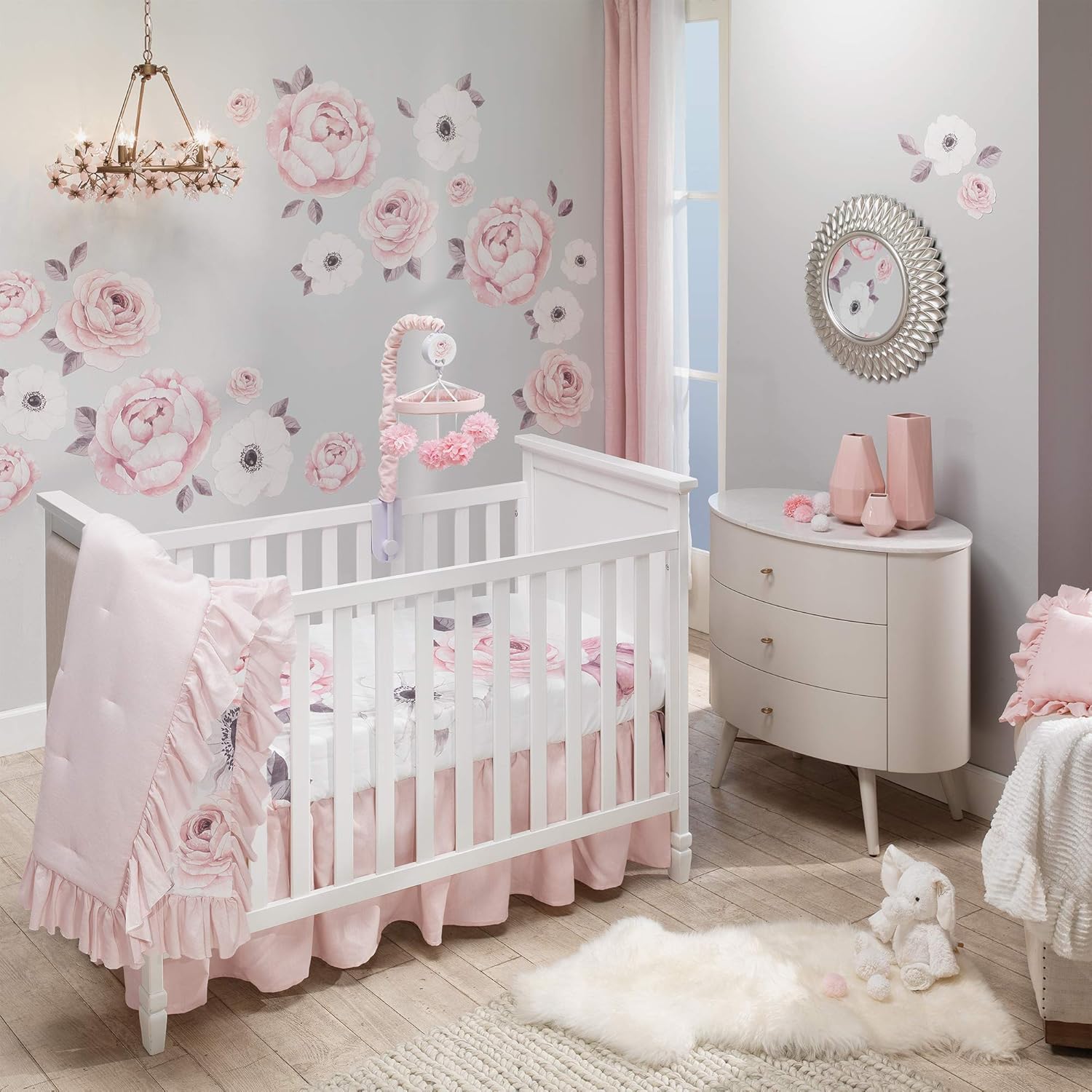 Lambs and Ivy Floral Garden Watercolor five piece baby crib bedding set laid out fully on a standard nursery crib.
