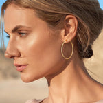 Gacimy thin hoop earrings lifestyle angle showing 50mm diameter size