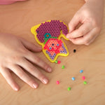 Children crafting designs with Perler fuse beads