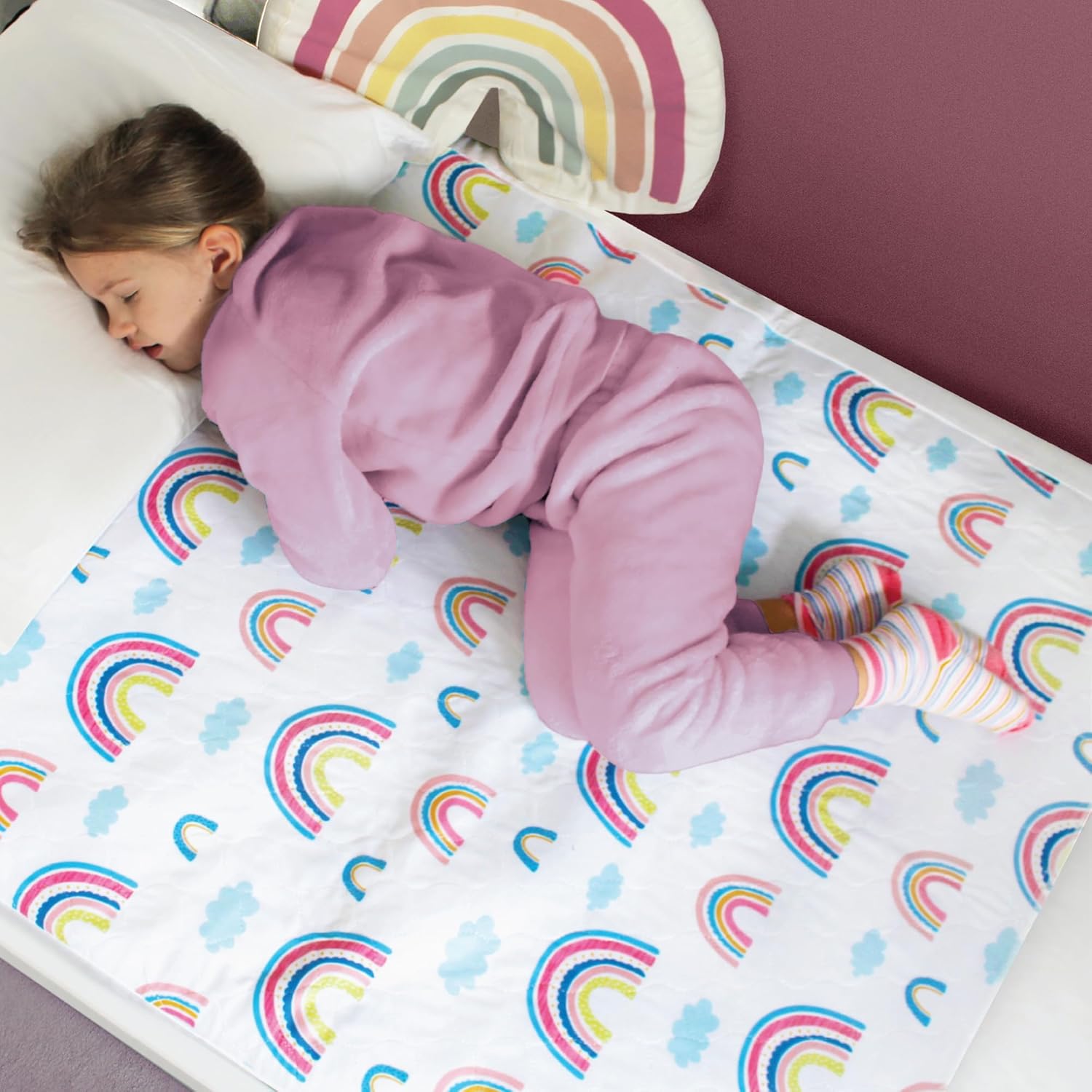 Hygge Supplies potty training bed pads front view showcasing the colorful rainbow pattern layout.
