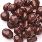 Close up of milk chocolate covered raisins on a wooden surface