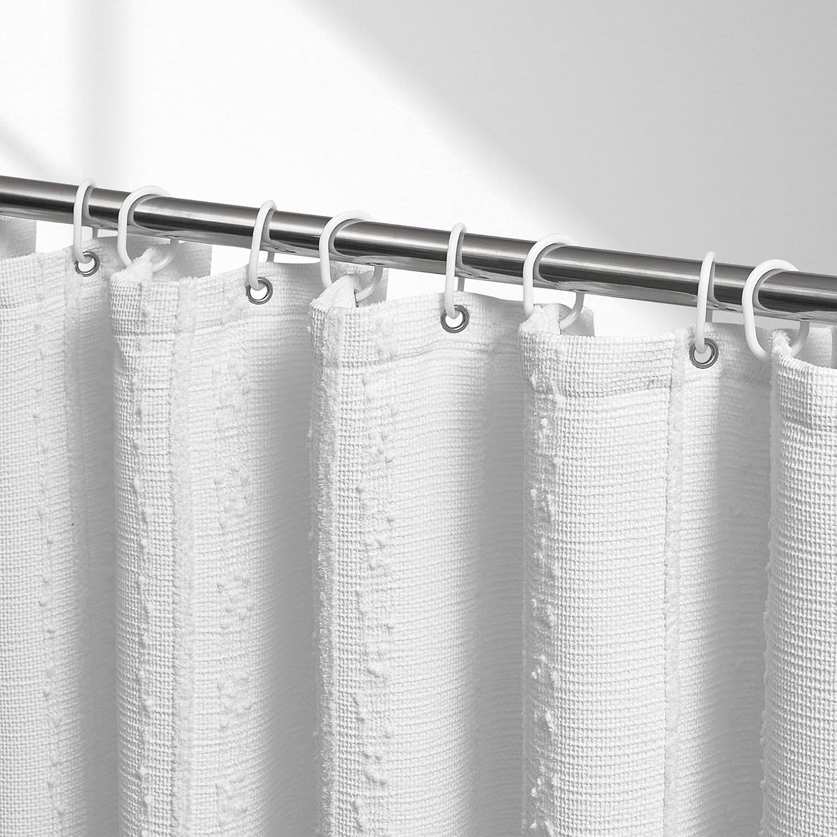 Lameirose white fabric shower curtain front view showing tufted stripe textures in a modern farmhouse bathroom setup.