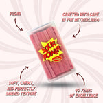 Sour Power strawberry candy belts being served out of the bulk jar using tongs