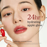 NOONI moisturizing lip oil bottle alongside fresh apple and goji berry elements.