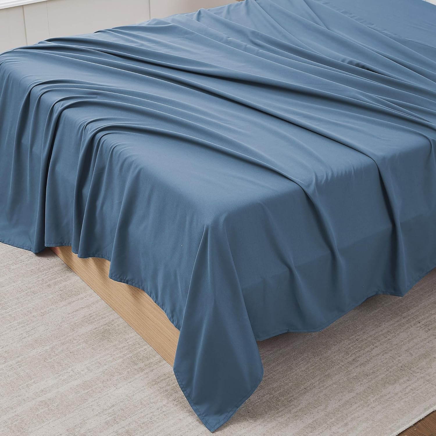 Sweet Home Collection King Flat Sheet Only front view of denim blue brushed microfiber bedding on a mattress.