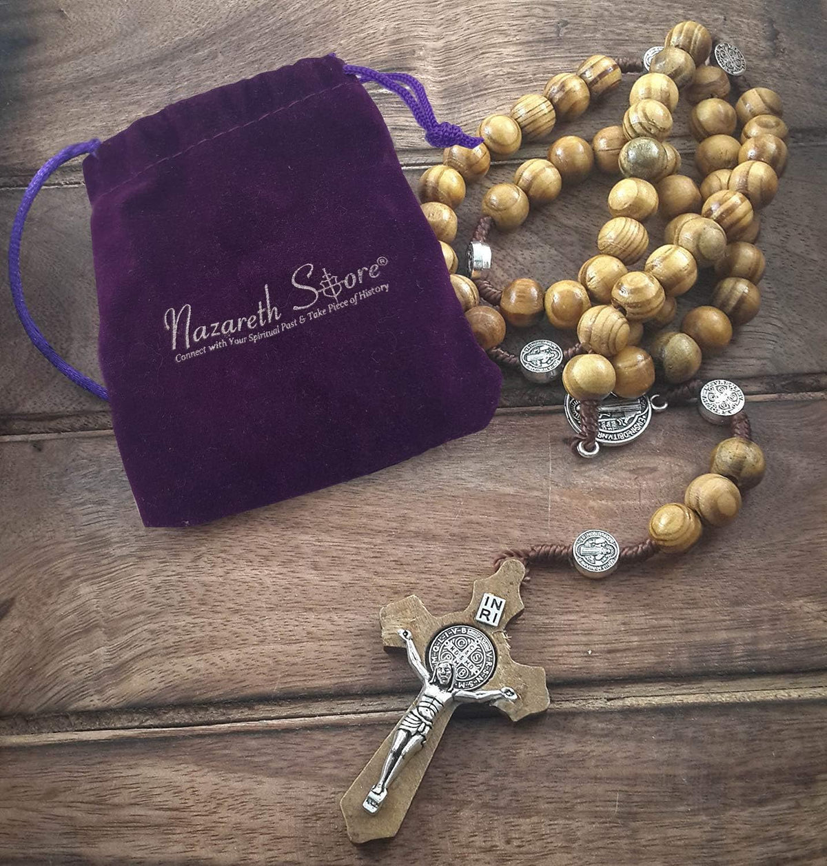 Close up view of the Saint Benedict medal and natural wood beads on the rosary