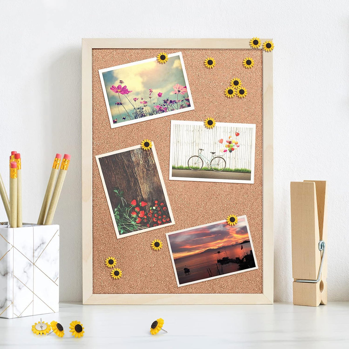 Yellow sunflower drawing pins arranged on office bulletin board