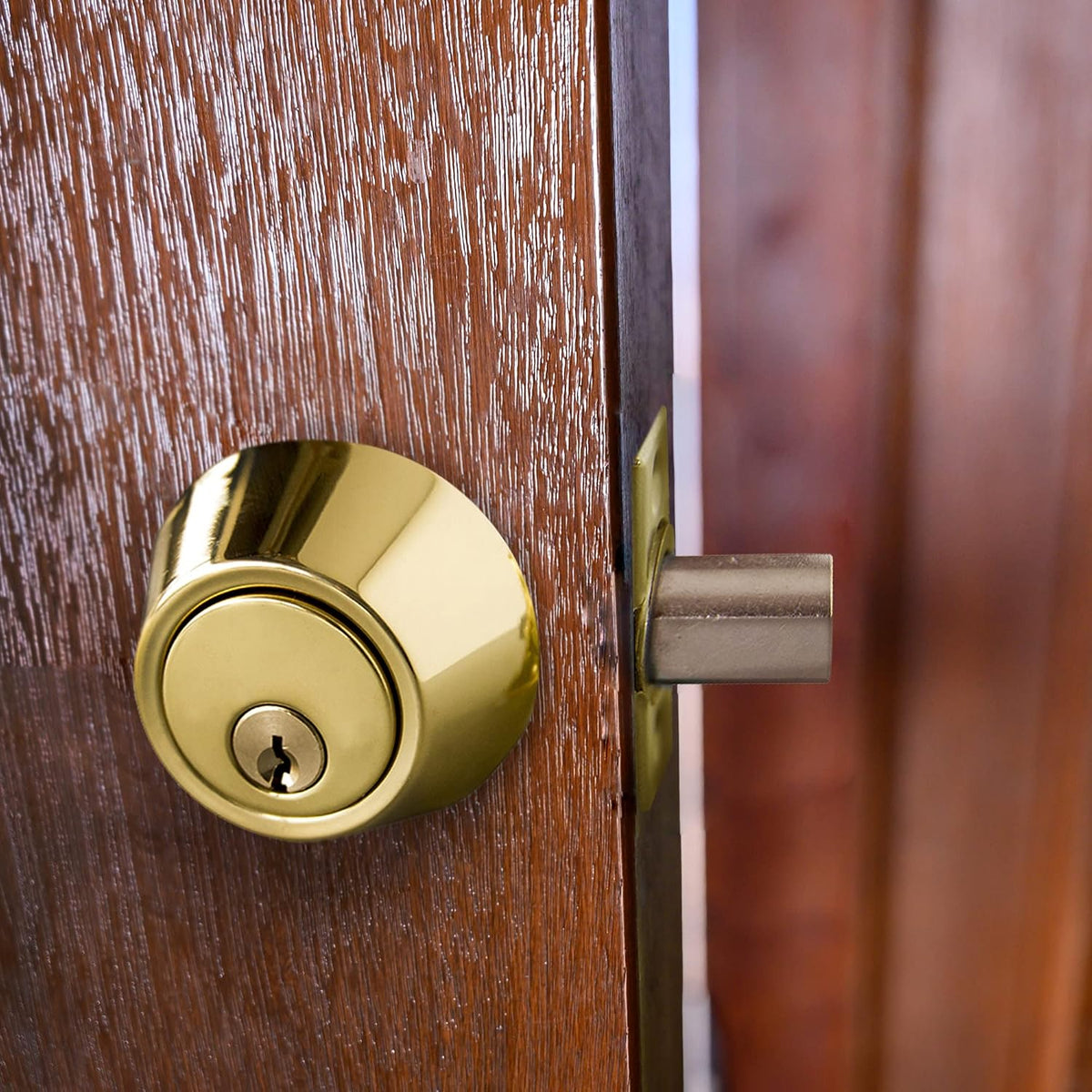 Design House polished brass deadbolt installed on door