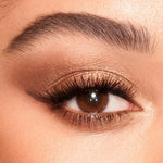 Swatches of Charlotte Tilbury eyeshadow quad on medium to deep skin tones.