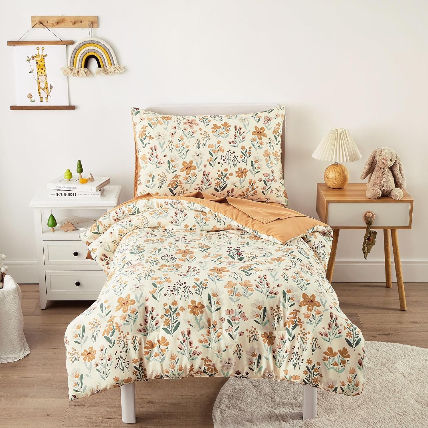 Wake In Cloud floral toddler bedding set front view showcasing orange cream botanical flower comforter on a crib.