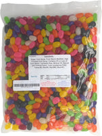 Mixed fruit and licorice flavored imported jelly beans spread on a clean surface