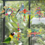 Small parrot pecking at a hanging bamboo chew toy inside a cage