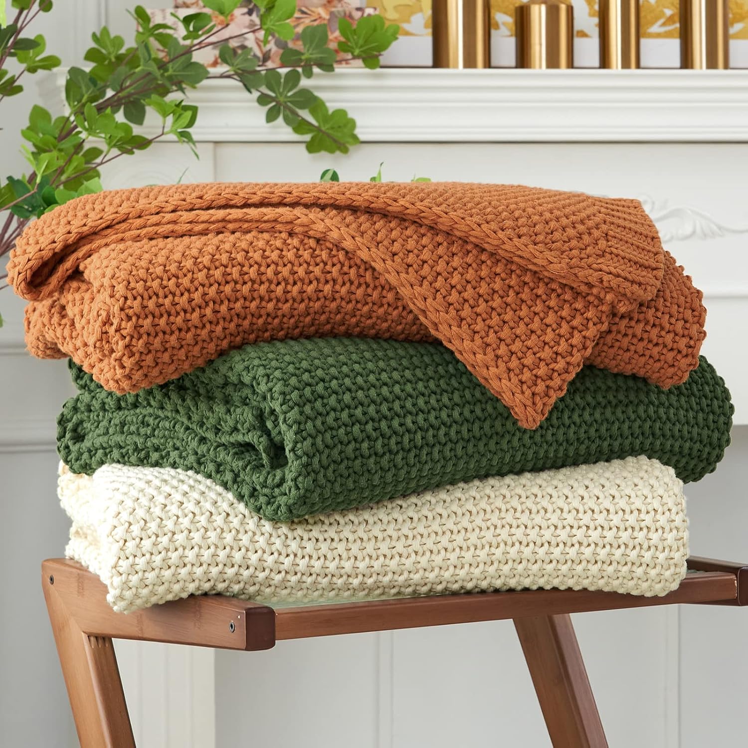 Longhui Bedding chunky cable knit throw blanket in beige draped on a couch